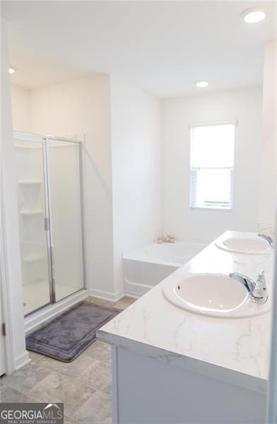 2159 Redfern, Dacula, GA 30019 - full bath featuring double vanity, a shower stall, a bath, and recessed lighting