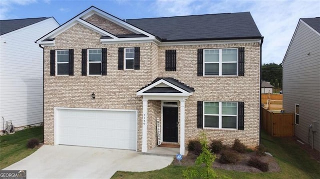 2159 Redfern, Dacula, GA 30019 - view of front of home with brick siding, an attached garage, and driveway
