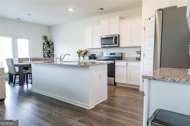 2159 Redfern, Dacula, GA 30019 - kitchen featuring appliances with stainless steel finishes, light stone countertops, dark wood-style flooring, and recessed lighting