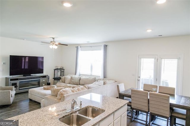 2159 Redfern, Dacula, GA 30019 - kitchen featuring open floor plan, light stone counters, ceiling fan, white cabinetry, and dark wood-type flooring
