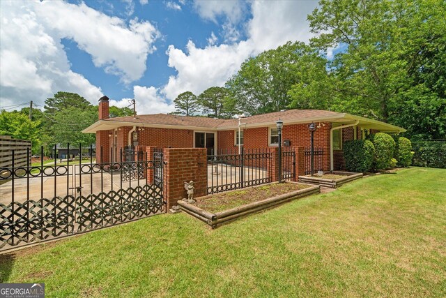 106 Lakeview Dr, Carrollton, GA 30117 - rear view of property with a chimney and brick siding