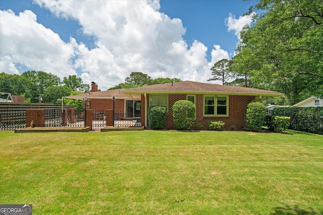 106 Lakeview Dr, Carrollton, GA 30117 - back of house with a chimney and brick siding