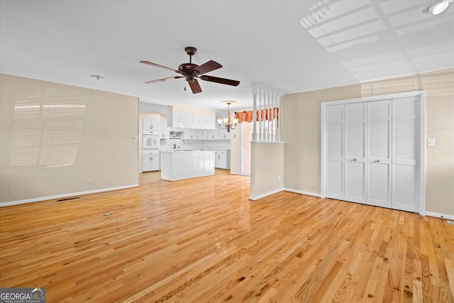 106 Lakeview Dr, Carrollton, GA 30117 - unfurnished living room with a chandelier, light wood-style flooring, and ceiling fan