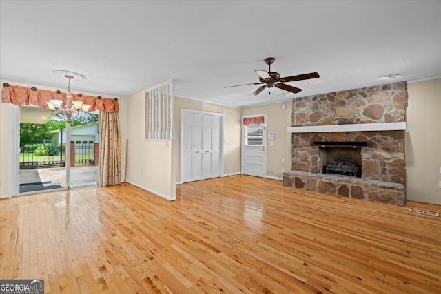 106 Lakeview Dr, Carrollton, GA 30117 - unfurnished living room featuring hardwood / wood-style floors, healthy amount of natural light, and a stone fireplace