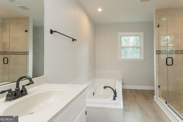 5674 Mountain Cres, Stone Mountain, GA 30087 - bathroom with a whirlpool tub, a shower stall, vanity, recessed lighting, and wood finished floors