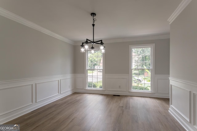 5674 Mountain Cres, Stone Mountain, GA 30087 - unfurnished room featuring a chandelier, wood finished floors, crown molding, a wainscoted wall, and a decorative wall