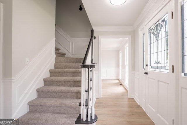 5674 Mountain Cres, Stone Mountain, GA 30087 - foyer with a decorative wall, stairs, wainscoting, ornamental molding, and light wood-type flooring