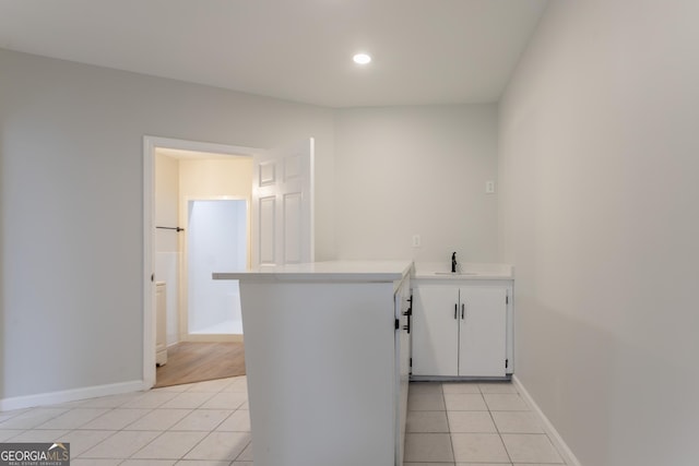 5674 Mountain Cres, Stone Mountain, GA 30087 - kitchen featuring light tile patterned floors, a peninsula, light countertops, recessed lighting, and white cabinetry