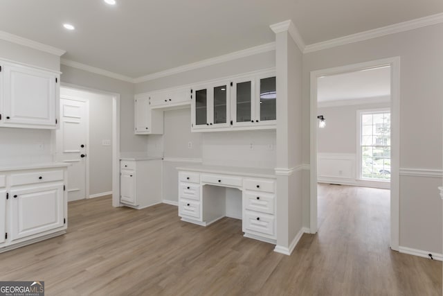 5674 Mountain Cres, Stone Mountain, GA 30087 - kitchen featuring light wood finished floors, white cabinets, crown molding, light countertops, and glass insert cabinets