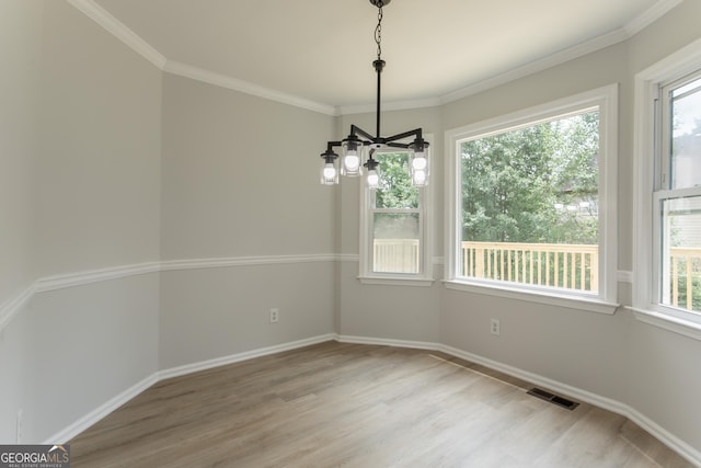 5674 Mountain Cres, Stone Mountain, GA 30087 - unfurnished dining area with light wood-style flooring, a chandelier, and crown molding