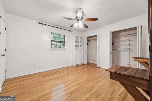 3123 Deshong Dr, Stone Mountain, GA 30087 - unfurnished bedroom featuring multiple closets, light wood finished floors, and ceiling fan