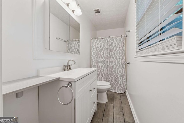 3123 Deshong Dr, Stone Mountain, GA 30087 - full bathroom featuring vanity, wood finished floors, a textured ceiling, and curtained shower