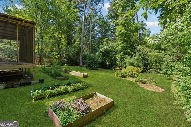 3123 Deshong Dr, Stone Mountain, GA 30087 - view of grassy yard with a vegetable garden