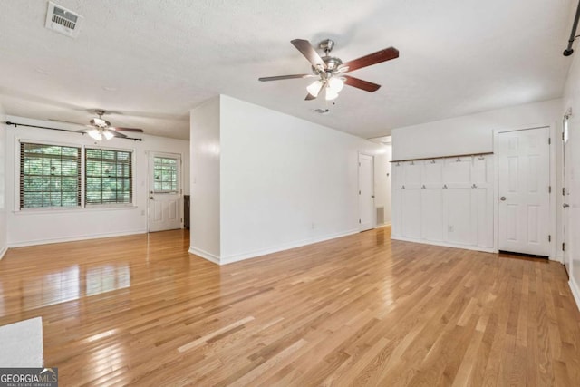 3123 Deshong Dr, Stone Mountain, GA 30087 - unfurnished living room with a ceiling fan, light wood-type flooring, and a textured ceiling
