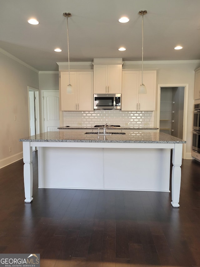 2424 Saint Andrews Rdg, College Park, GA 30337 - kitchen featuring stainless steel appliances, an island with sink, decorative backsplash, pendant lighting, and ornamental molding