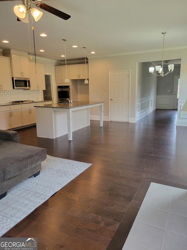 2424 Saint Andrews Rdg, College Park, GA 30337 - living room with crown molding, a ceiling fan, a chandelier, dark wood-style floors, and recessed lighting