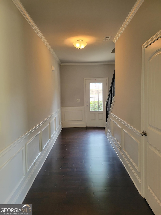 2424 Saint Andrews Rdg, College Park, GA 30337 - spare room featuring crown molding, dark wood-style floors, stairs, a decorative wall, and a wainscoted wall