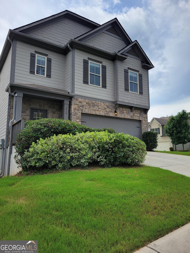 2424 Saint Andrews Rdg, College Park, GA 30337 - craftsman-style home featuring a garage, stone siding, a front lawn, and driveway