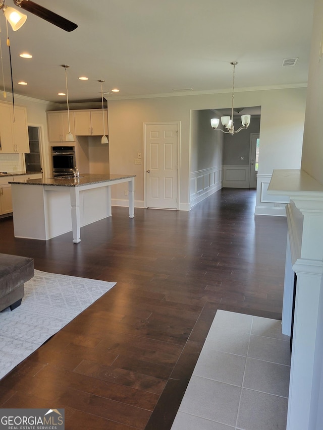 2424 Saint Andrews Rdg, College Park, GA 30337 - unfurnished living room with crown molding, a chandelier, dark wood-style flooring, recessed lighting, and a ceiling fan