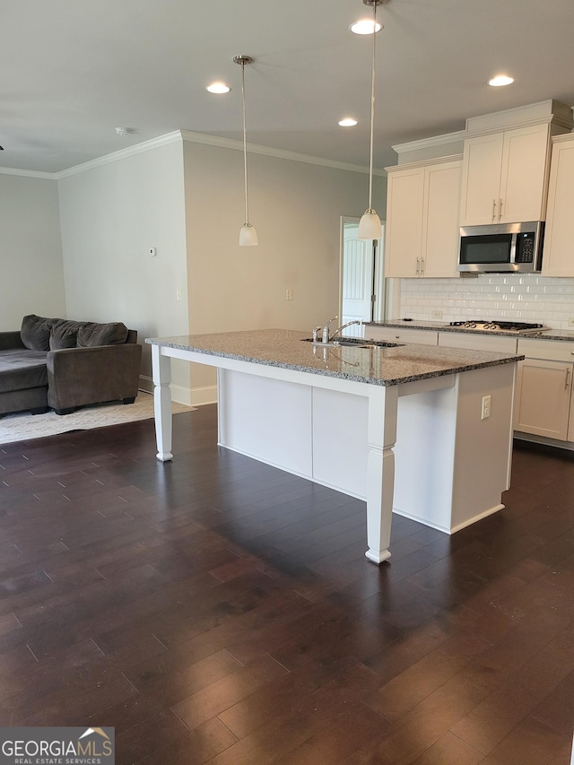 2424 Saint Andrews Rdg, College Park, GA 30337 - kitchen with stainless steel microwave, ornamental molding, recessed lighting, tasteful backsplash, and a kitchen bar