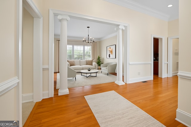 152 Lace Field Ln, Lavonia, GA 30553 - hallway with crown molding, light wood-style flooring, a chandelier, decorative columns, and recessed lighting
