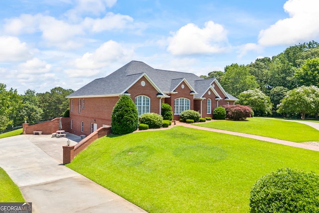 152 Lace Field Ln, Lavonia, GA 30553 - view of front of house with brick siding, a front yard, roof with shingles, and driveway