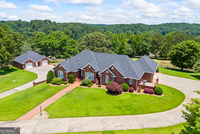 152 Lace Field Ln, Lavonia, GA 30553 - traditional home with curved driveway, a wooded view, a detached garage, roof with shingles, and brick siding