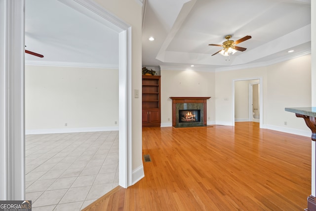 152 Lace Field Ln, Lavonia, GA 30553 - unfurnished living room with ceiling fan, a fireplace, crown molding, a tray ceiling, and recessed lighting