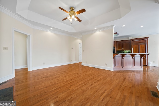 152 Lace Field Ln, Lavonia, GA 30553 - unfurnished living room with a ceiling fan, a raised ceiling, light wood-style flooring, ornamental molding, and recessed lighting