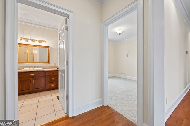 152 Lace Field Ln, Lavonia, GA 30553 - hallway featuring crown molding, light wood-style flooring, and light colored carpet