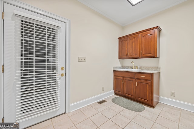 152 Lace Field Ln, Lavonia, GA 30553 - laundry room with ornamental molding, wet bar, and light tile patterned flooring