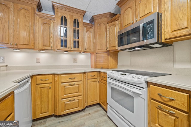 152 Lace Field Ln, Lavonia, GA 30553 - kitchen with white appliances, light wood finished floors, glass insert cabinets, and light countertops