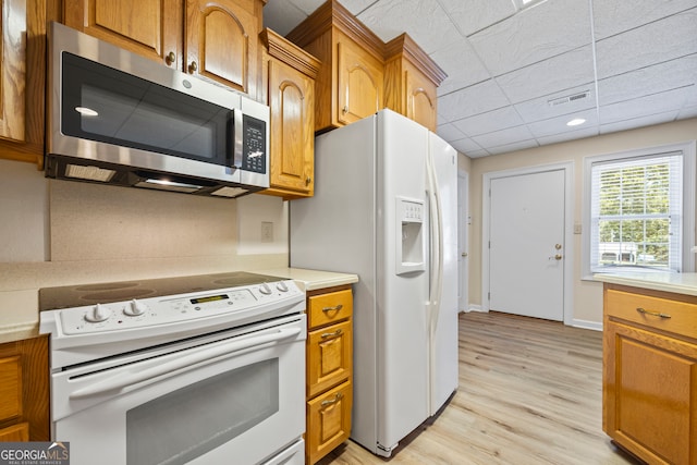 152 Lace Field Ln, Lavonia, GA 30553 - kitchen featuring white appliances, light countertops, light wood-style flooring, brown cabinets, and a drop ceiling