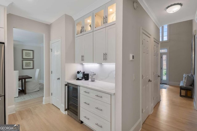 5414 Manteo Inlt, Peachtree Corners, GA 30092 - indoor dry bar with beverage cooler, light wood-type flooring, ornamental molding, and freestanding refrigerator