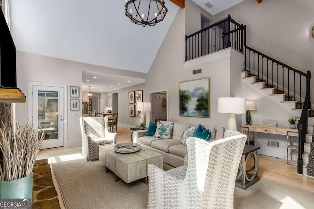 5414 Manteo Inlt, Peachtree Corners, GA 30092 - living room featuring a chandelier, high vaulted ceiling, stairs, and wood finished floors