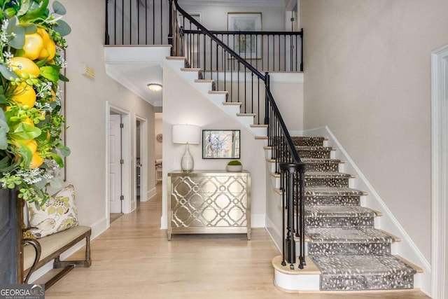 5414 Manteo Inlt, Peachtree Corners, GA 30092 - staircase with wood finished floors, ornamental molding, and a high ceiling