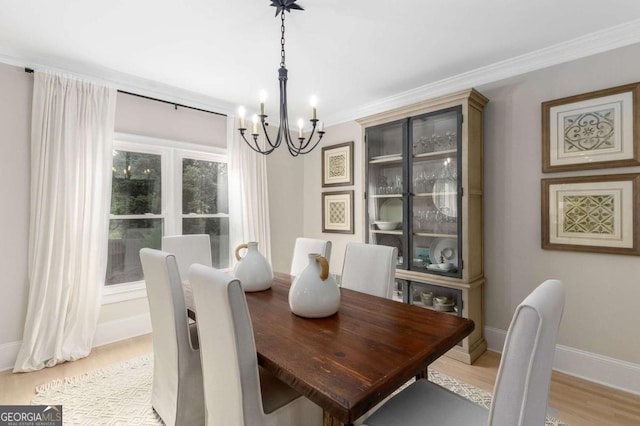 5414 Manteo Inlt, Peachtree Corners, GA 30092 - dining space featuring a chandelier, light wood-style flooring, and ornamental molding