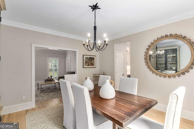 5414 Manteo Inlt, Peachtree Corners, GA 30092 - dining room featuring a chandelier, light wood-style floors, and ornamental molding