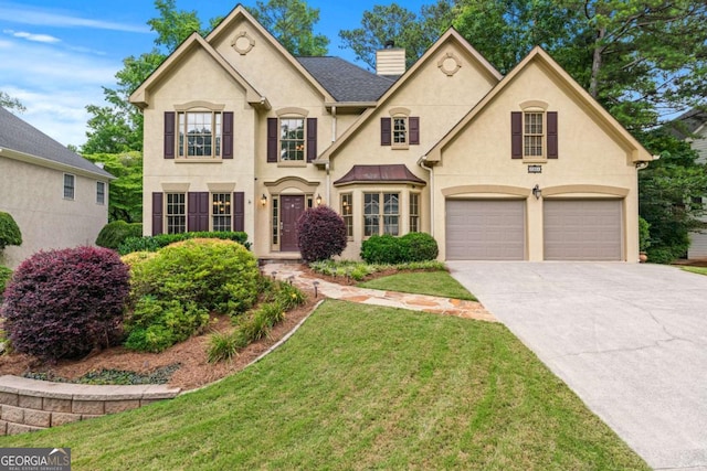 2864 Wyndcliff Ct, Marietta, GA 30066 - view of front of property with stucco siding, a chimney, concrete driveway, a garage, and a front yard