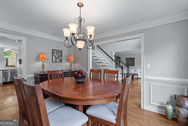 2864 Wyndcliff Ct, Marietta, GA 30066 - dining room with stairway, a chandelier, wood finished floors, and crown molding