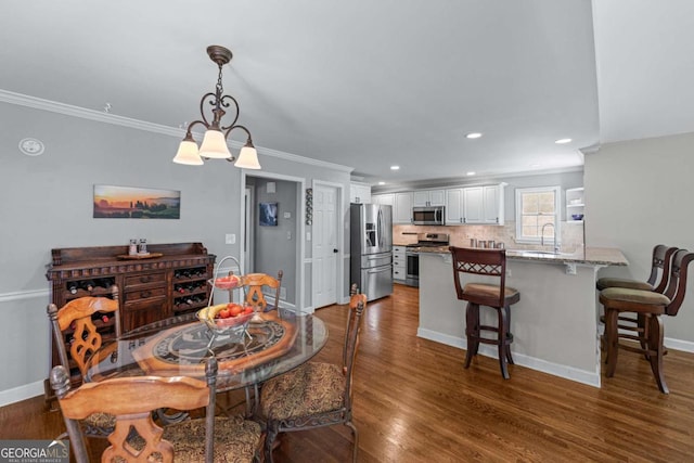 2864 Wyndcliff Ct, Marietta, GA 30066 - dining room with ornamental molding, dark wood-type flooring, and recessed lighting