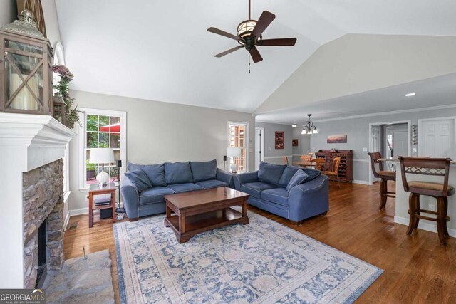 2864 Wyndcliff Ct, Marietta, GA 30066 - living area with a fireplace, a ceiling fan, wood finished floors, a chandelier, and high vaulted ceiling