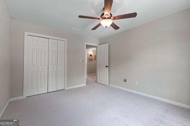 2864 Wyndcliff Ct, Marietta, GA 30066 - unfurnished bedroom featuring light carpet, a closet, and a ceiling fan