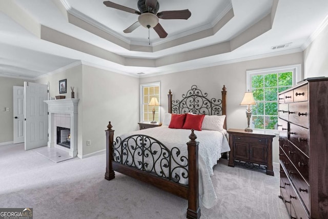 2864 Wyndcliff Ct, Marietta, GA 30066 - bedroom with carpet flooring, a tray ceiling, ornamental molding, a tiled fireplace, and ceiling fan