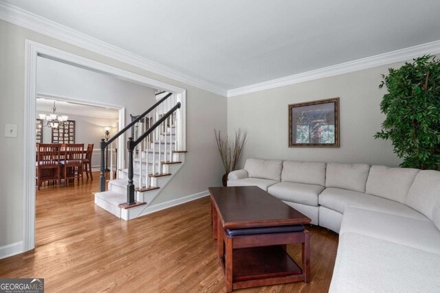 2864 Wyndcliff Ct, Marietta, GA 30066 - living room featuring crown molding, light wood finished floors, stairs, and a chandelier