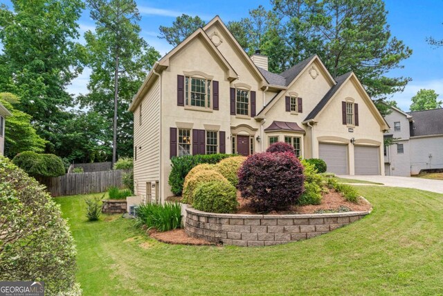 2864 Wyndcliff Ct, Marietta, GA 30066 - view of front of home featuring concrete driveway, stucco siding, a chimney, and an attached garage