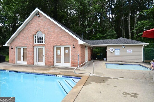 2864 Wyndcliff Ct, Marietta, GA 30066 - community pool featuring french doors, a storage structure, an outbuilding, and a patio area
