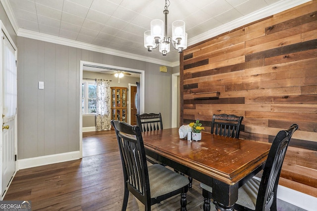 1083 Hampton Rd, Hampton, GA 30228 - dining room with a chandelier, crown molding, wood-type flooring, and wooden walls