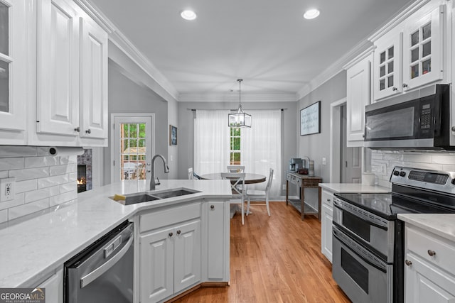 1436 Virginia Way, Monroe, GA 30655 - kitchen featuring stainless steel appliances, backsplash, white cabinetry, light wood-type flooring, and recessed lighting