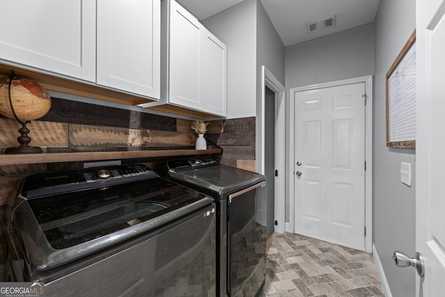 1436 Virginia Way, Monroe, GA 30655 - laundry room featuring separate washer and dryer, cabinet space, and light stone finish floors